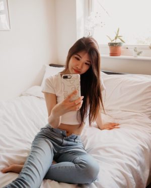 sitting on bed with phone
